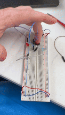 A working switch for 3 LEDs on a breadboard. Electricity is a trip.