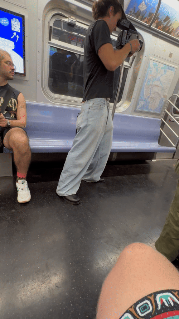 Filming someone taking someone's photo on Subway